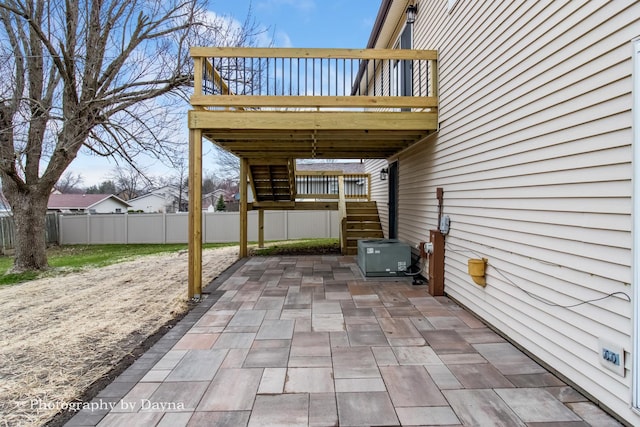 view of patio / terrace with a fenced backyard, central AC unit, stairway, and a wooden deck