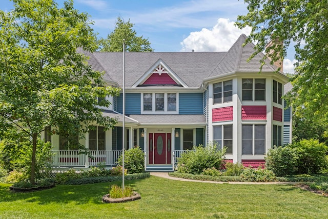 18040 Perth Ave, Homewood, IL 60430 - victorian home featuring a front yard, covered porch, a chimney, and roof with shingles