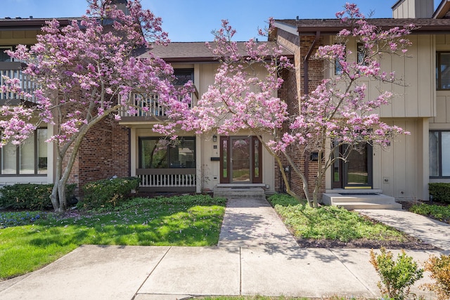 7 Kane Ct, Willowbrook, IL 60527 - view of front of home featuring board and batten siding, a balcony, and brick siding