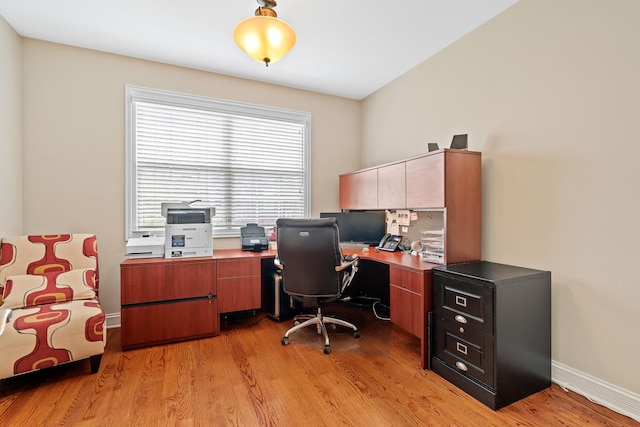 office space featuring baseboards and light wood finished floors