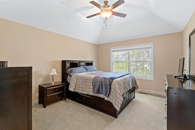 bedroom featuring a ceiling fan, baseboards, vaulted ceiling, and light carpet