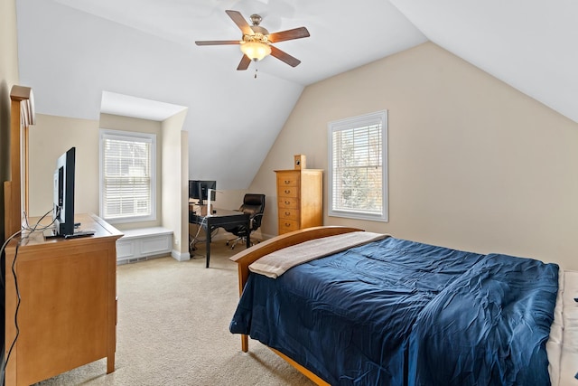 bedroom with multiple windows, lofted ceiling, and light colored carpet