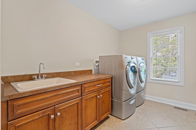 laundry room with a sink, plenty of natural light, cabinet space, and washer and clothes dryer