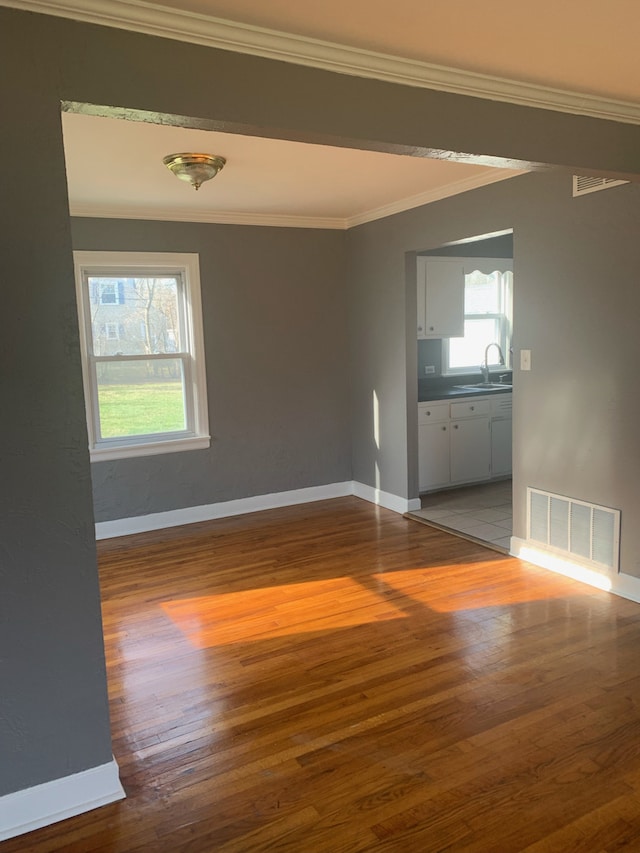 26W441 Geneva Rd, Wheaton, IL 60187 - unfurnished room with a sink, visible vents, baseboards, ornamental molding, and wood finished floors