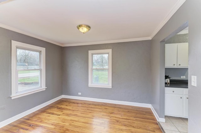 26W441 Geneva Rd, Wheaton, IL 60187 - unfurnished room with crown molding, a textured wall, baseboards, and light wood-type flooring