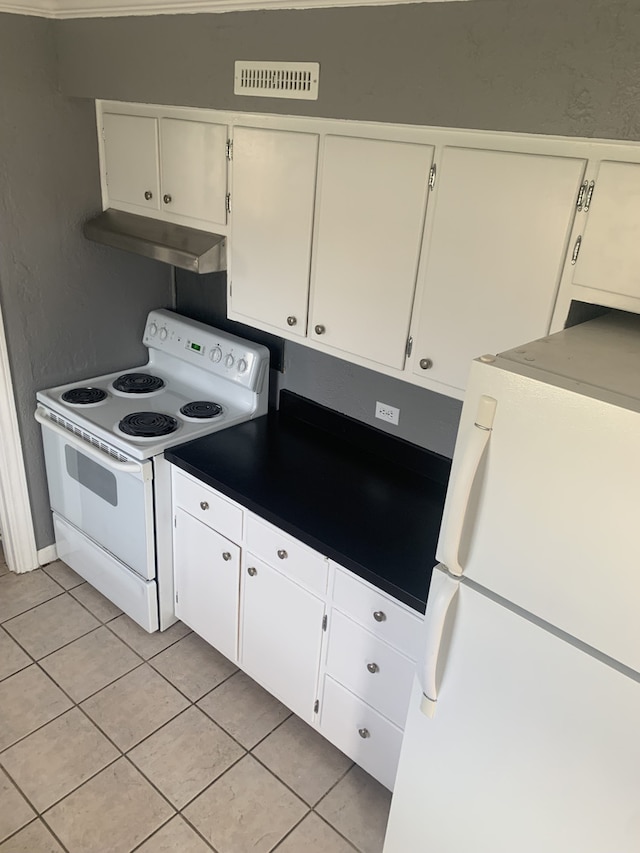 26W441 Geneva Rd, Wheaton, IL 60187 - kitchen with under cabinet range hood, light tile patterned flooring, visible vents, white appliances, and dark countertops