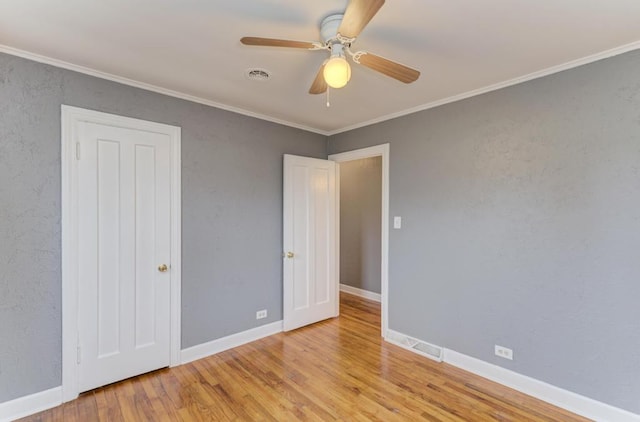 26W441 Geneva Rd, Wheaton, IL 60187 - unfurnished bedroom with ornamental molding, wood finished floors, visible vents, and baseboards
