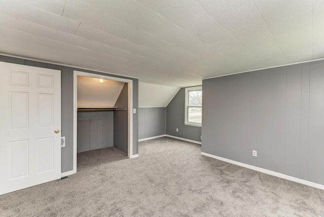 26W441 Geneva Rd, Wheaton, IL 60187 - unfurnished bedroom featuring a walk in closet, a closet, baseboards, and carpet floors