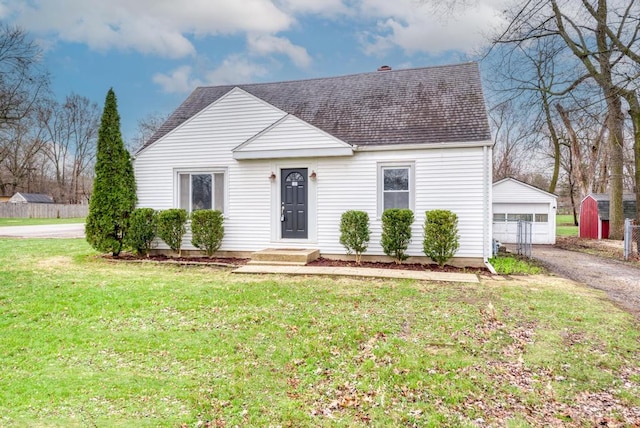 26W441 Geneva Rd, Wheaton, IL 60187 - view of front of house with a garage, a front lawn, a shingled roof, and an outbuilding