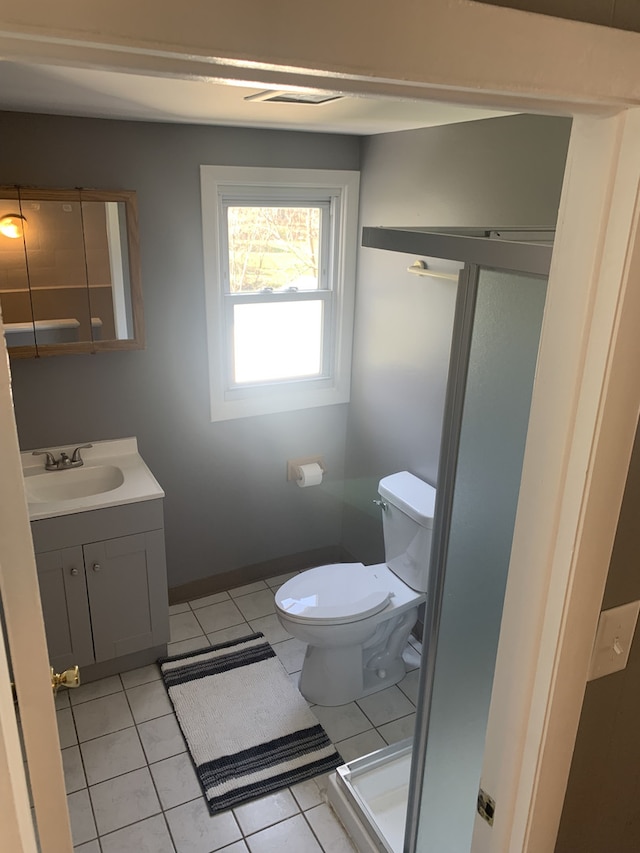 26W441 Geneva Rd, Wheaton, IL 60187 - bathroom with toilet, tile patterned floors, vanity, and baseboards