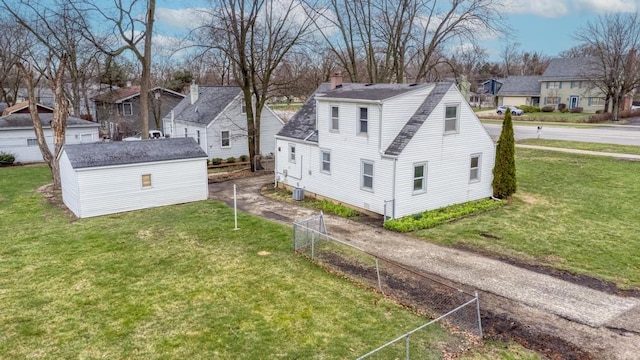 26W441 Geneva Rd, Wheaton, IL 60187 - view of side of home with a chimney, fence, a residential view, roof with shingles, and a lawn