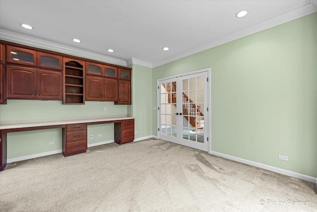 unfurnished office with ornamental molding, built in study area, recessed lighting, light colored carpet, and french doors