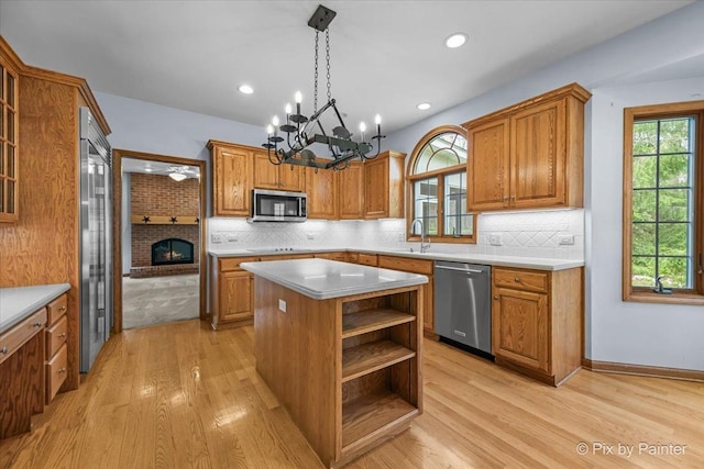 kitchen featuring brown cabinetry, a center island, and stainless steel appliances