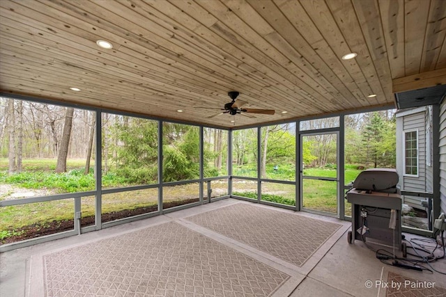 sunroom / solarium with a ceiling fan and plenty of natural light