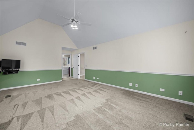 interior space with carpet floors, a ceiling fan, high vaulted ceiling, and visible vents