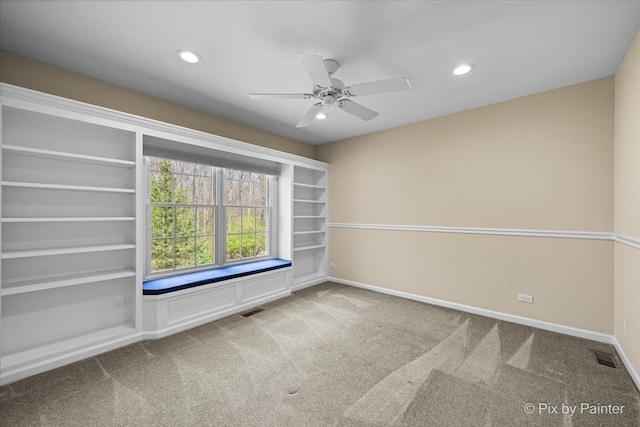 carpeted spare room featuring recessed lighting, a ceiling fan, baseboards, and visible vents