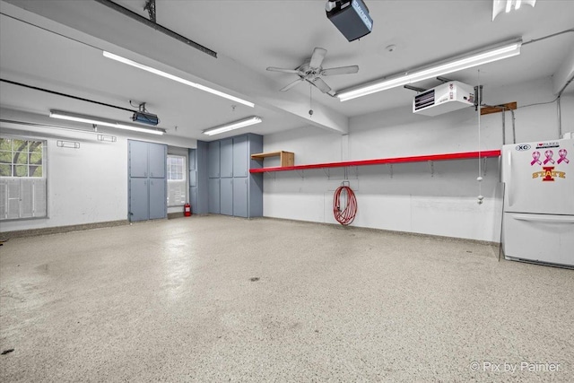 garage with baseboards, freestanding refrigerator, and a ceiling fan