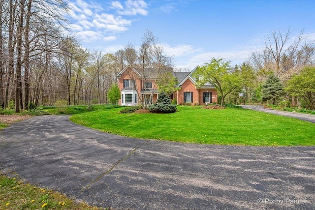 view of front facade with a front lawn and driveway