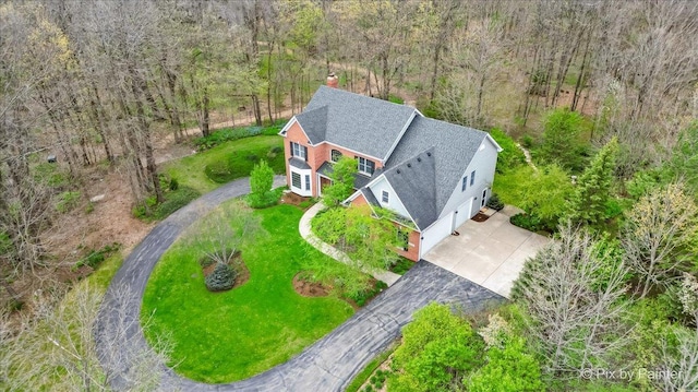 birds eye view of property with a view of trees