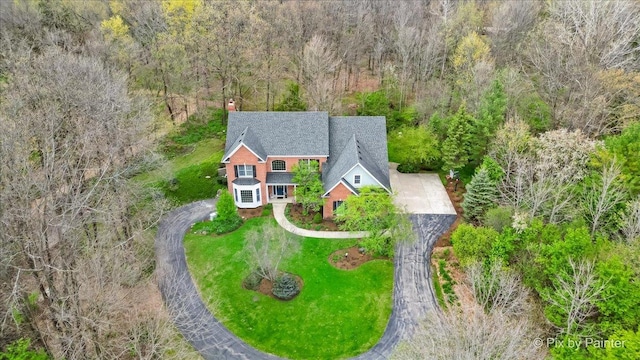drone / aerial view featuring a forest view