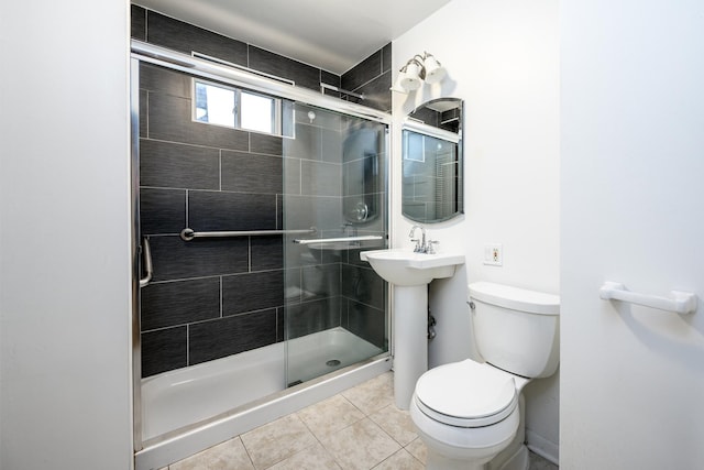 full bath featuring toilet, tile patterned floors, and a stall shower