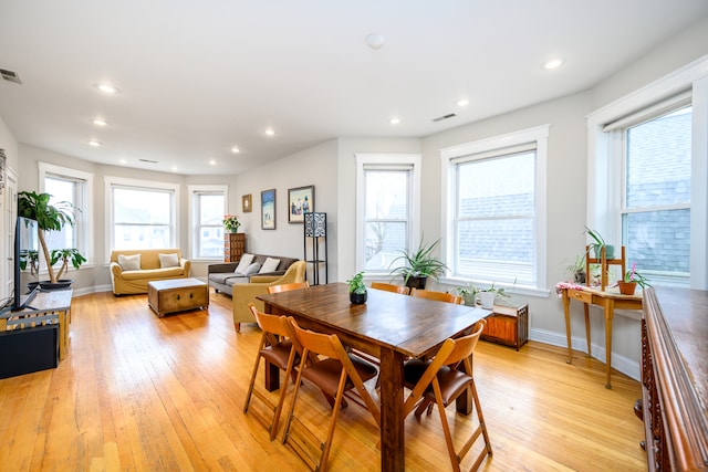 dining space with recessed lighting, light wood finished floors, and visible vents