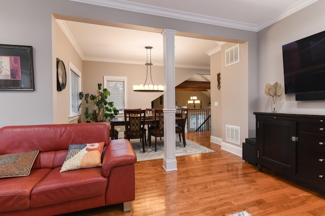 111 Grace Ln, Fox River Grove, IL 60021 - living room with visible vents, ornamental molding, light wood-style flooring, and decorative columns