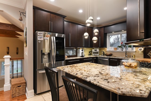 111 Grace Ln, Fox River Grove, IL 60021 - kitchen with backsplash, light stone countertops, dark brown cabinets, a peninsula, and stainless steel appliances