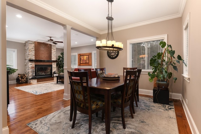 111 Grace Ln, Fox River Grove, IL 60021 - dining room featuring ornamental molding, ceiling fan with notable chandelier, wood finished floors, and a fireplace