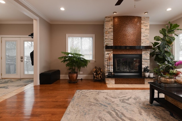 111 Grace Ln, Fox River Grove, IL 60021 - living room featuring a stone fireplace, french doors, a ceiling fan, wood finished floors, and ornamental molding