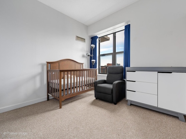 bedroom featuring carpet flooring, baseboards, visible vents, and a nursery area