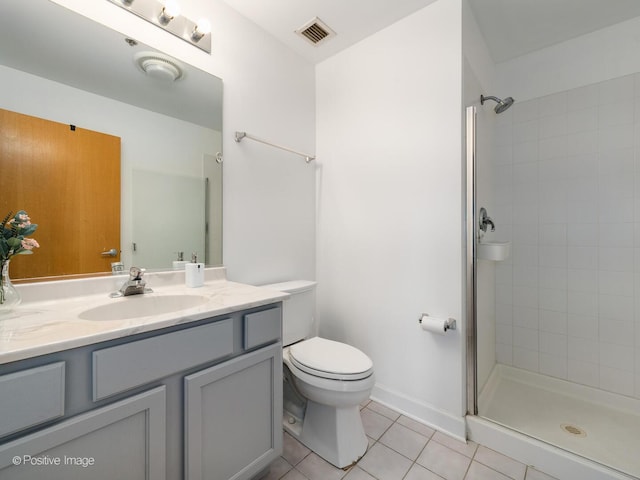 full bath with visible vents, toilet, vanity, tiled shower, and tile patterned flooring