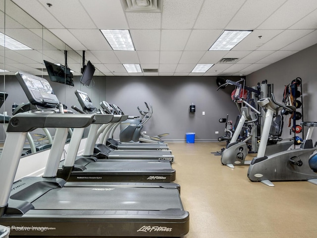 gym featuring visible vents, baseboards, and a paneled ceiling
