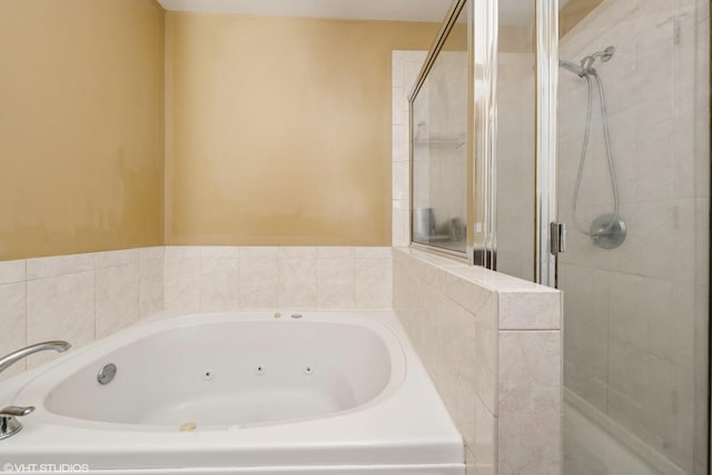 bathroom featuring a stall shower and a whirlpool tub
