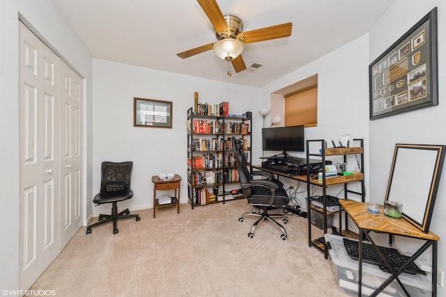 home office featuring carpet flooring, a ceiling fan, baseboards, and visible vents
