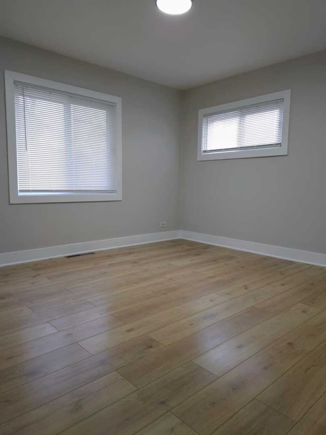 16117 Wolcott Ave, Markham, IL 60428 - unfurnished room with visible vents, light wood-style flooring, and baseboards