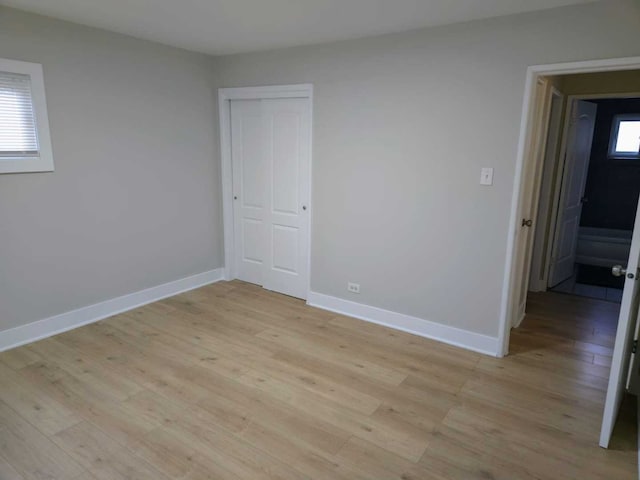 16117 Wolcott Ave, Markham, IL 60428 - unfurnished bedroom featuring light wood-type flooring, a closet, and baseboards