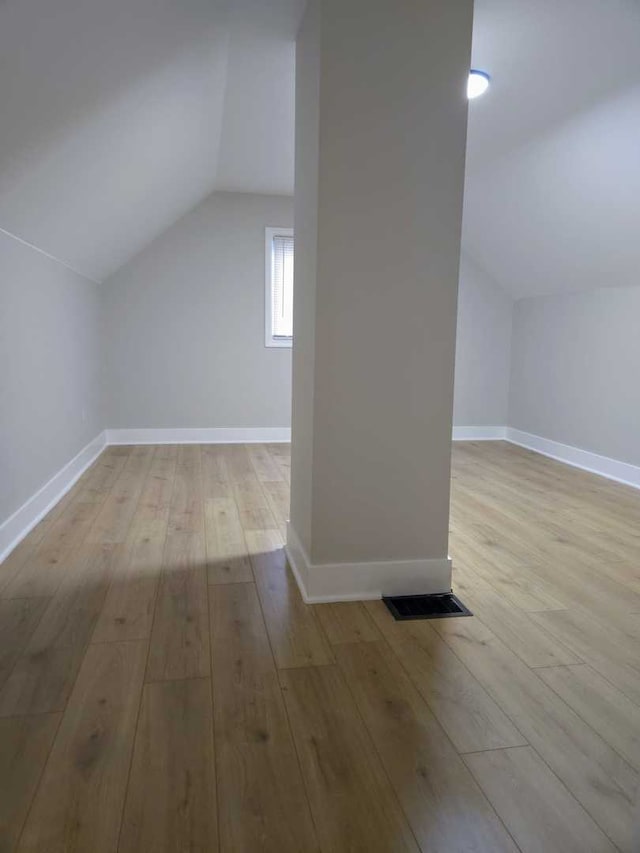 16117 Wolcott Ave, Markham, IL 60428 - additional living space with wood-type flooring, baseboards, visible vents, and lofted ceiling