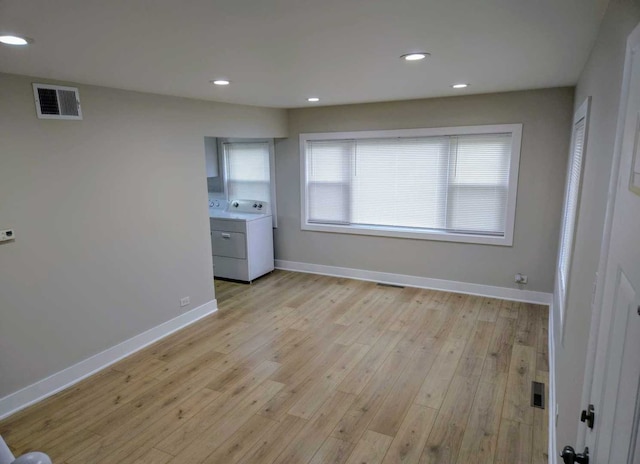 16117 Wolcott Ave, Markham, IL 60428 - empty room featuring washer / clothes dryer, light wood-type flooring, baseboards, recessed lighting, and visible vents