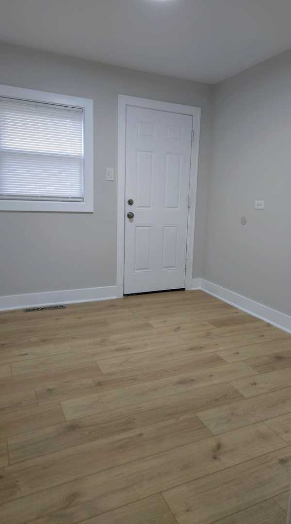 16117 Wolcott Ave, Markham, IL 60428 - entryway featuring visible vents, baseboards, and light wood finished floors