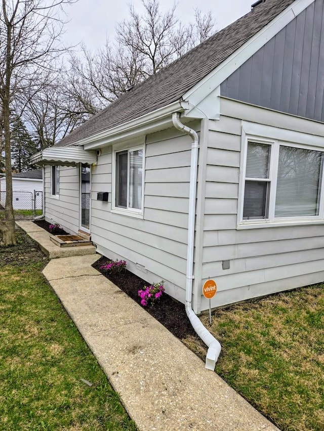 16117 Wolcott Ave, Markham, IL 60428 - exterior space with a lawn, fence, and a shingled roof