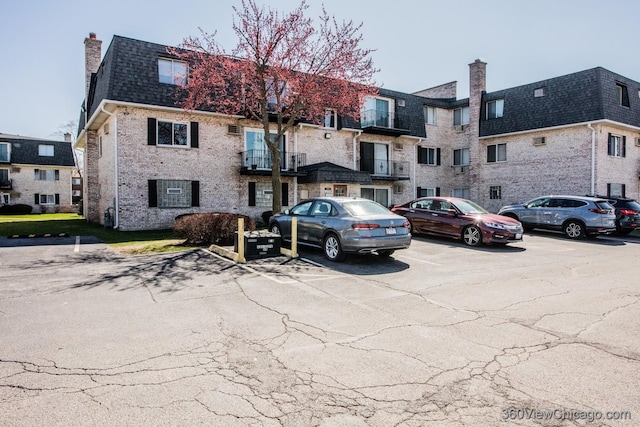 view of property featuring uncovered parking