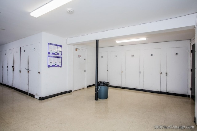 interior space with tile patterned floors and baseboards