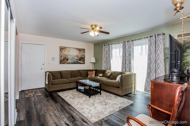 living room with dark wood-type flooring and a ceiling fan