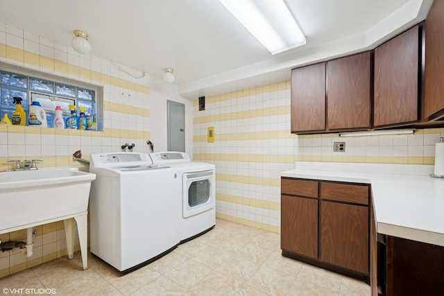 6920 N Avers Ave, Lincolnwood, IL 60712 - laundry area featuring light tile patterned flooring, electric panel, tile walls, washer and dryer, and cabinet space