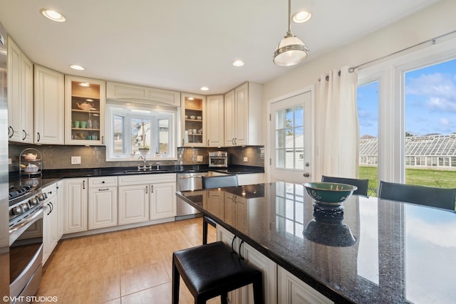 6920 N Avers Ave, Lincolnwood, IL 60712 - kitchen featuring backsplash, a kitchen bar, stainless steel appliances, and a sink