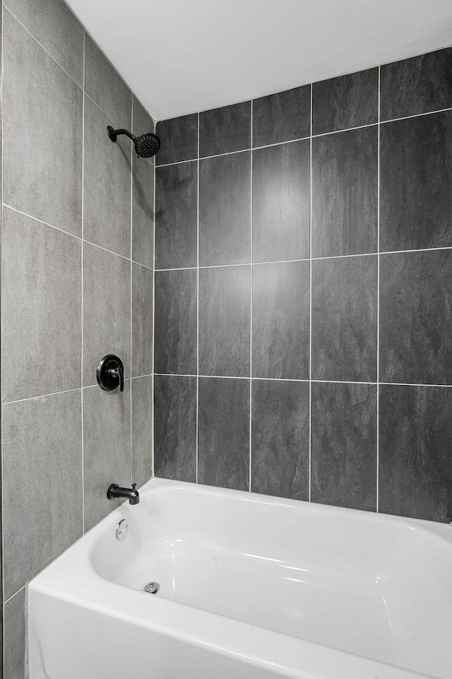 bathroom with bathing tub / shower combination