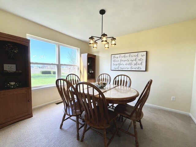 102 W Auburndale Ave, Cortland, IL 60112 - dining area with baseboards, light carpet, and a chandelier