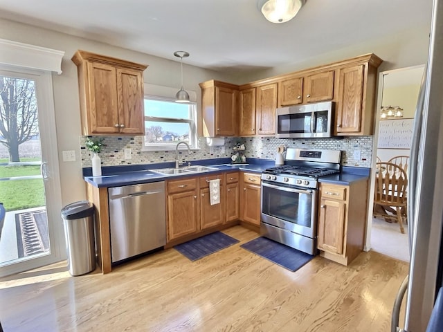 102 W Auburndale Ave, Cortland, IL 60112 - kitchen with a sink, light wood finished floors, appliances with stainless steel finishes, and dark countertops