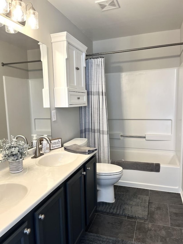 102 W Auburndale Ave, Cortland, IL 60112 - bathroom featuring double vanity, toilet, visible vents, and a sink